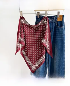 Close-up of wine red silk scarf with white geometric patterns and ethnic motifs texture