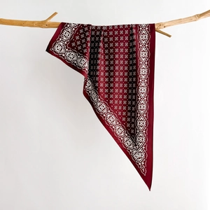 Vintage burgundy geometric silk scarf draped on a branch for elegant spring styling