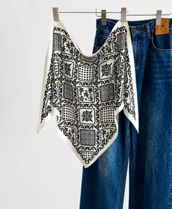 Close-up of lightweight silk scarf with vintage floral patterns and geometric polka dots