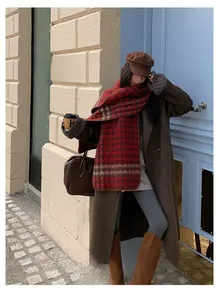 Detail of red-brown houndstooth scarf paired with dark brown wool coat and boots