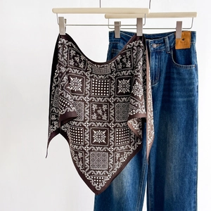 Brown vintage paisley silk scarf for women displayed with denim jeans for a stylish look
