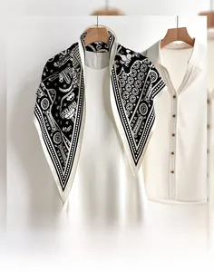 Detailed view of women's neck scarf with black and white bohemian geometric floral patterns