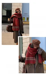 Detail of red and black houndstooth wool scarf paired with a brown wool coat and newsboy cap