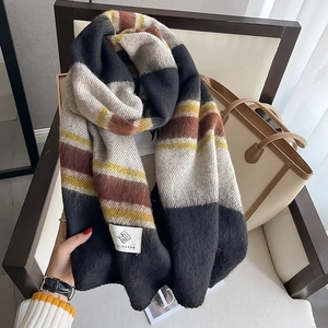 Close-up of thick striped knit scarf texture and stylish woven label detail