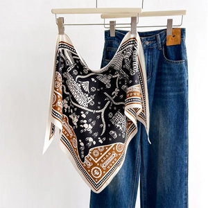 Elegant silk triangle scarf with retro architecture print paired with denim jeans