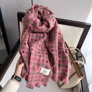 Detail of pink plaid scarf showing unique hollowed-out distressed knit texture and soft fabric