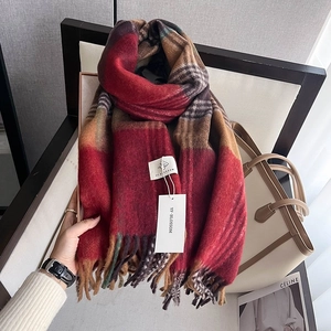 Detail of soft houndstooth scarf texture with fringe tassels and premium thick fabric