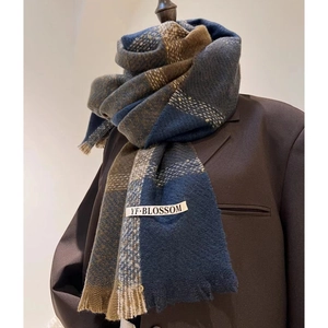 Detail of blue and brown houndstooth scarf with soft fringe and brand label