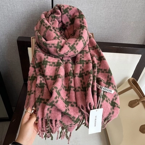 Detail of pink and green houndstooth scarf with soft fringe and brand label