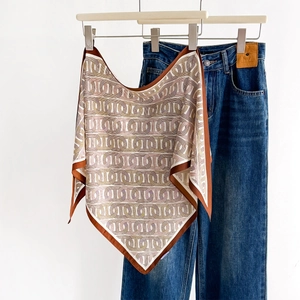 Spring printed silk-like triangle scarf with geometric chain pattern on denim background