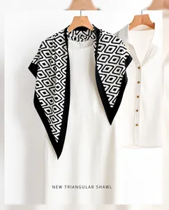 Detailed close-up of a double-sided diamond print silk shawl with contrast black piping edge