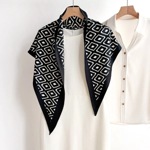 Minimalist black and white diamond pattern silk scarf shawl on a white dress