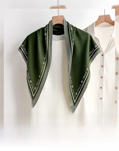 Close-up of elegant dark green silk triangle scarf with white stripes and brand lettering