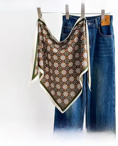 Detailed view of vintage French silk scarf with geometric mandala pattern on hanger