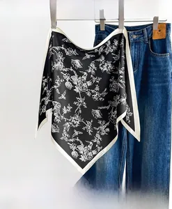 Close-up of lightweight floral silk scarf paired with denim for a stylish casual look