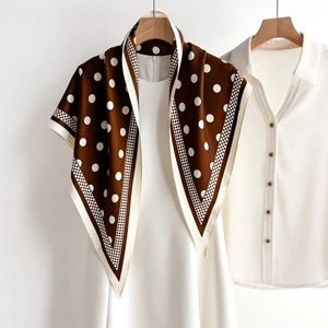 Polka dot silk scarf in dark brown and white styled with a white dress for commuting