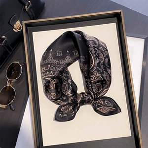 Classic silk scarf with gold paisley pattern and satin finish on black background