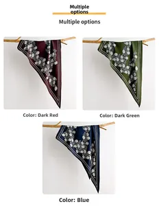 Detailed display of vintage floral silk scarves in red, green and blue on wooden branches