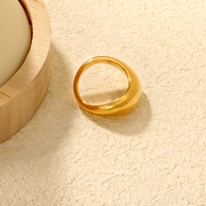 Detailed view of thick 18K gold plated stainless steel dome ring on a minimalist background