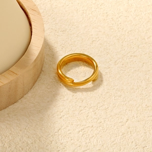 Detail view of 18K gold plated stainless steel irregular wrap ring on stone background