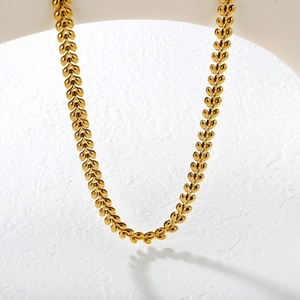 Elegant 18k gold plated wheat leaf link chain necklace on a textured white background