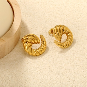 Detail of 18K gold plated C-shaped spiral hoop earrings with vintage shell texture