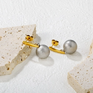 Minimalist gold and silver two-tone drop earrings with matte metal ball pendants