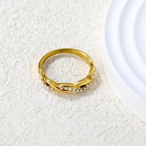 Braided gold ring for women featuring small white pearls in a twisted design