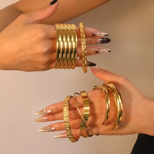 Minimalist 18K gold plated stainless steel stacked bracelets with a polished finish