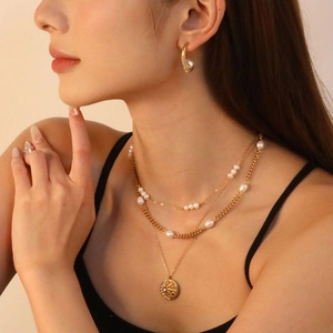 Layered 18K gold plated stainless steel necklace with freshwater pearls and sun medallion