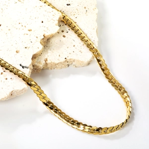 Flat gold curb chain necklace made of 18K gold plated stainless steel on natural stone