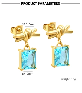 Detail view of 18K gold bow earrings with light blue zircon and dimensions 13.3x6mm