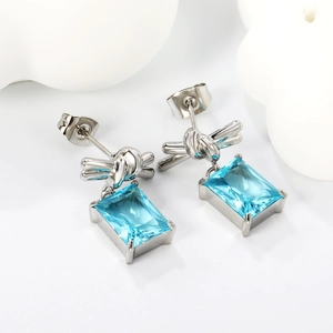 Modern 18K gold-plated stainless steel bow earrings with light blue rectangular zircon