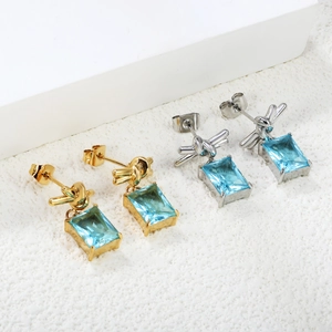 Knot earrings in 18K gold and silver with rectangular light blue zircon drops