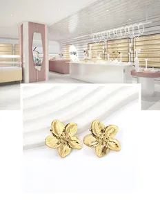 Macro shot of 18K gold plated flower stud earrings with detailed petal texture