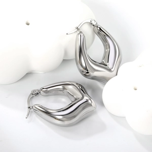 Polished silver U-shaped stainless steel chunky hoop earrings on a white artistic stand