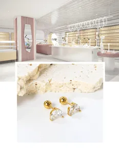 Macro view of 18K gold plated steel leaf earrings featuring marquise-cut white zircons