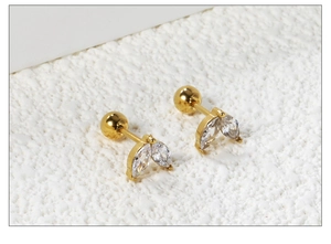 Macro shot of 18K gold plated steel stud earrings with marquise cut white zircons