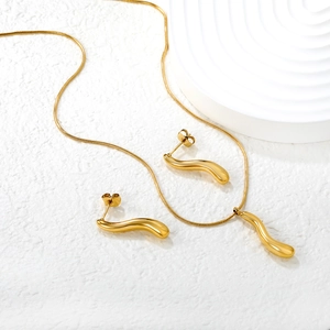 Minimalist gold geometric jewelry set with a fluid pendant necklace and stud earrings