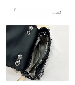 Macro view of black sequin bag interior featuring large capacity multi-compartment storage