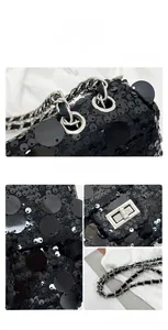 Close-up of black sequined crossbody bag featuring a metal twist lock and woven chain strap