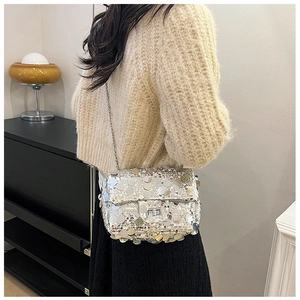 Detail of silver sequin chain bag showing reflective texture and elegant evening style