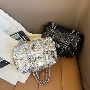 Chic sequined flap bag with metal chain strap and twist-lock closure in black and silver