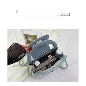 Detail view of the spacious inner compartments of the quilted chain bucket bag