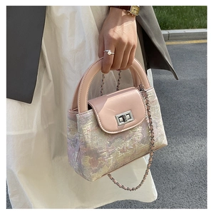 Detail of the pink leather flap and colorful jacquard texture on the bucket bag