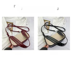 Detail of woven straw and leather crossbody bags with silver rivet studs in red and black