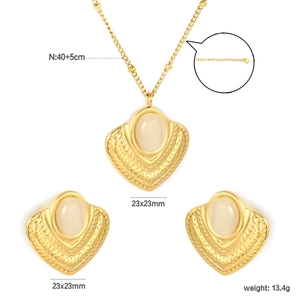 Detail view of gold fan necklace and earrings set with emerald cat-eye stones and dimensions