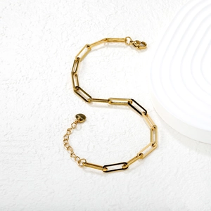 Gold stainless steel paperclip link bracelet with adjustable lobster clasp on white background