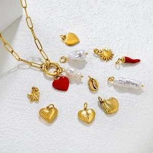 Detailed view of 18K gold stainless steel paperclip necklace with pearl and heart charms