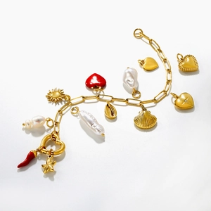 Detail of 18K gold stainless steel bracelet with heart, pearl and shell charms